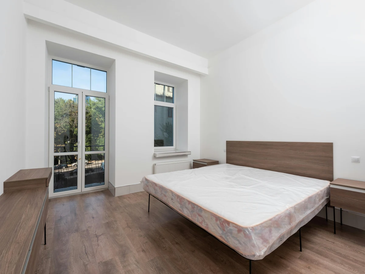 Bedroom with grey accent feature wall painted by Derby Painters