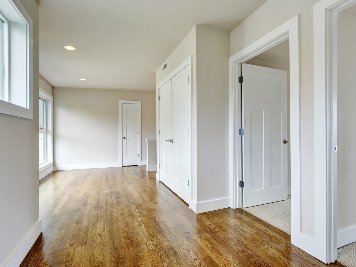 Fence painting in Derby - hand applying dark wood stain to timber fence by Derby Painters