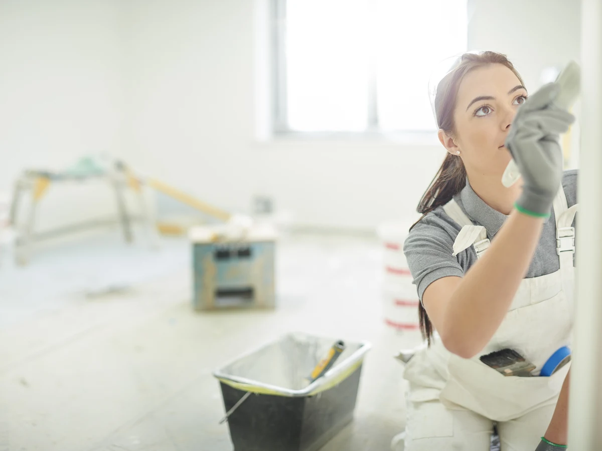 Female painter smoothing paint in Spondon by Derby Painters, professional decorating service