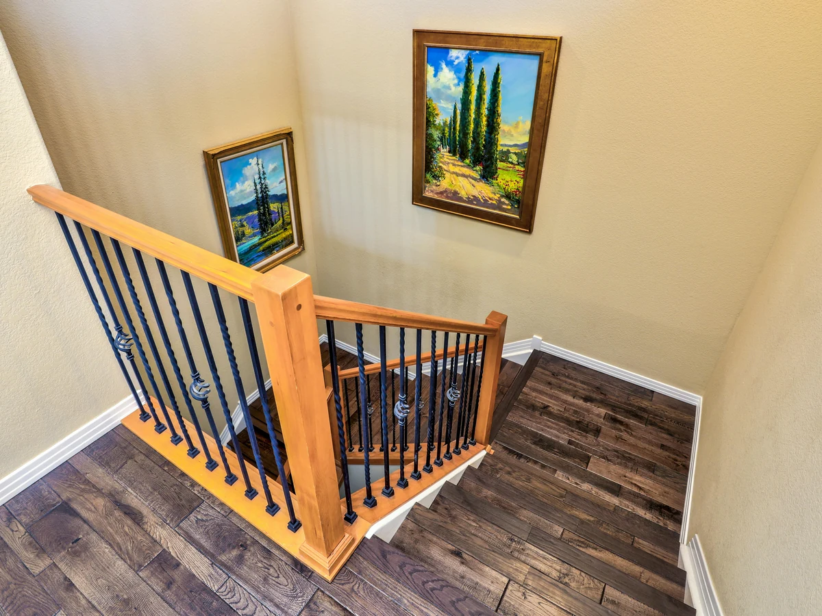 Painter on ladder rolling ceiling in Derby property